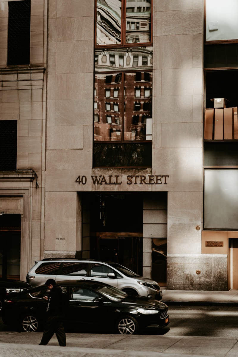 40 Wall Street facade with passing cars