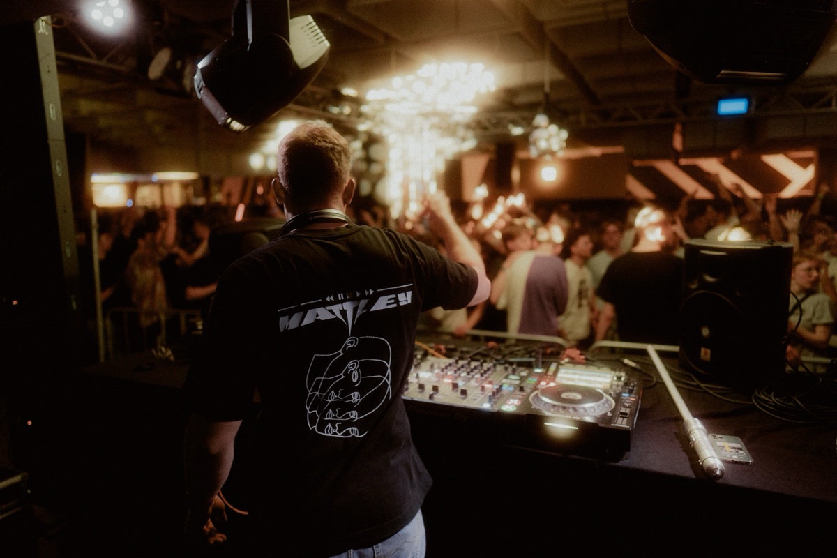 DJ from behind in a crowded venue
