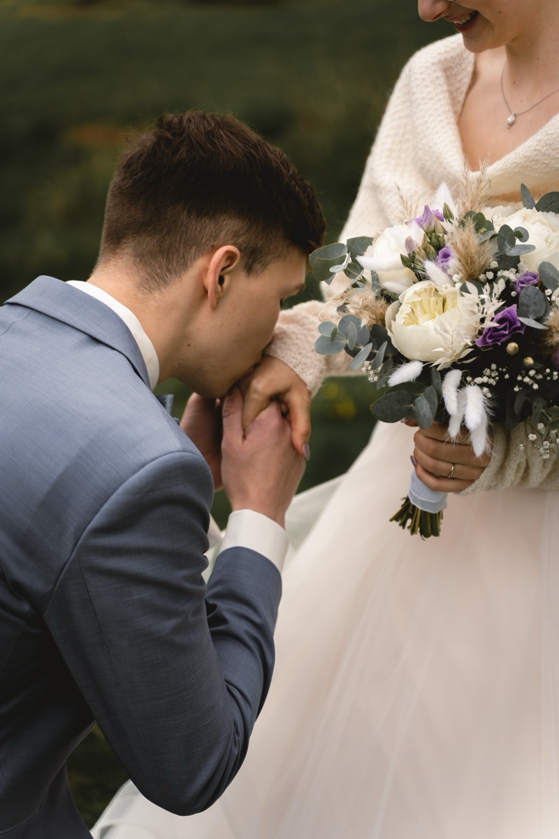 Groom kissing the bride’s hand