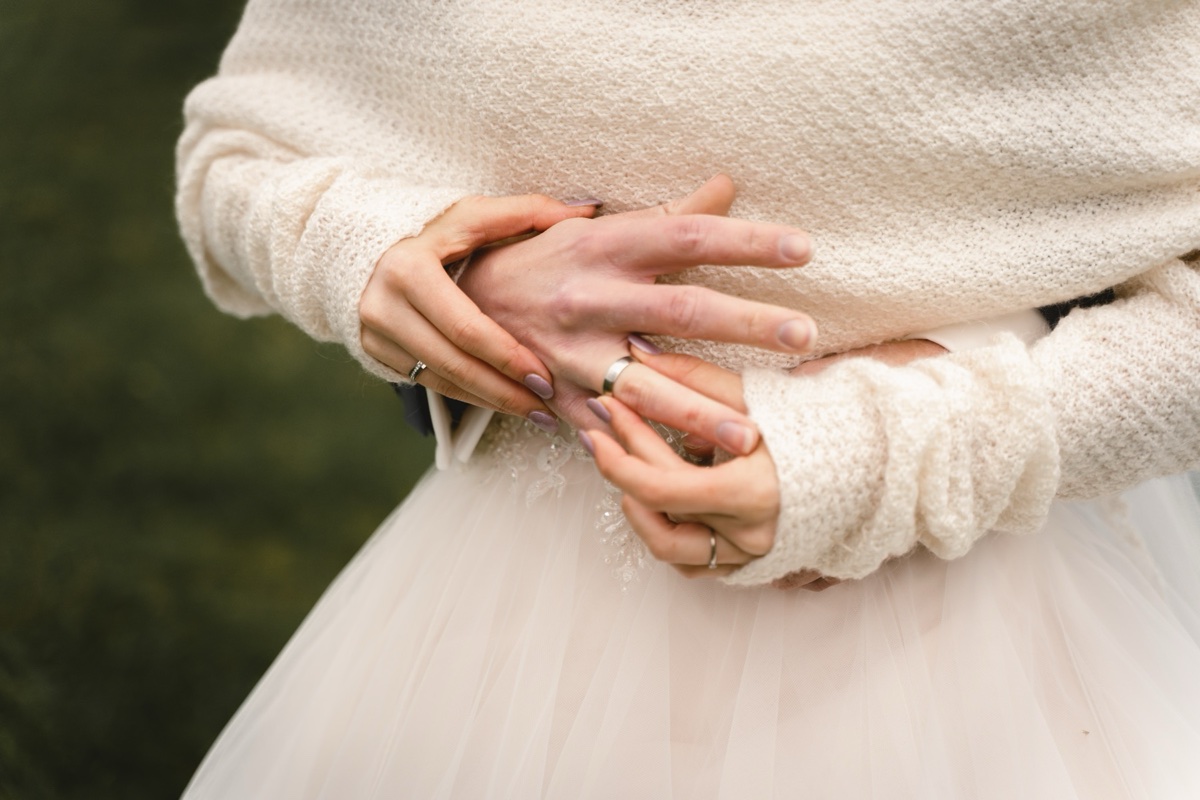 Wedding hands detail over tulle
